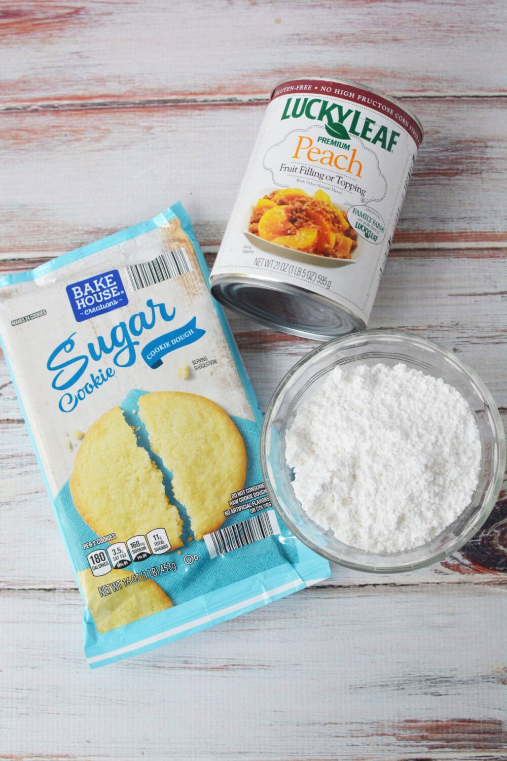 Canned peach pie filling, sugar cookie dough, and powdered sugar.