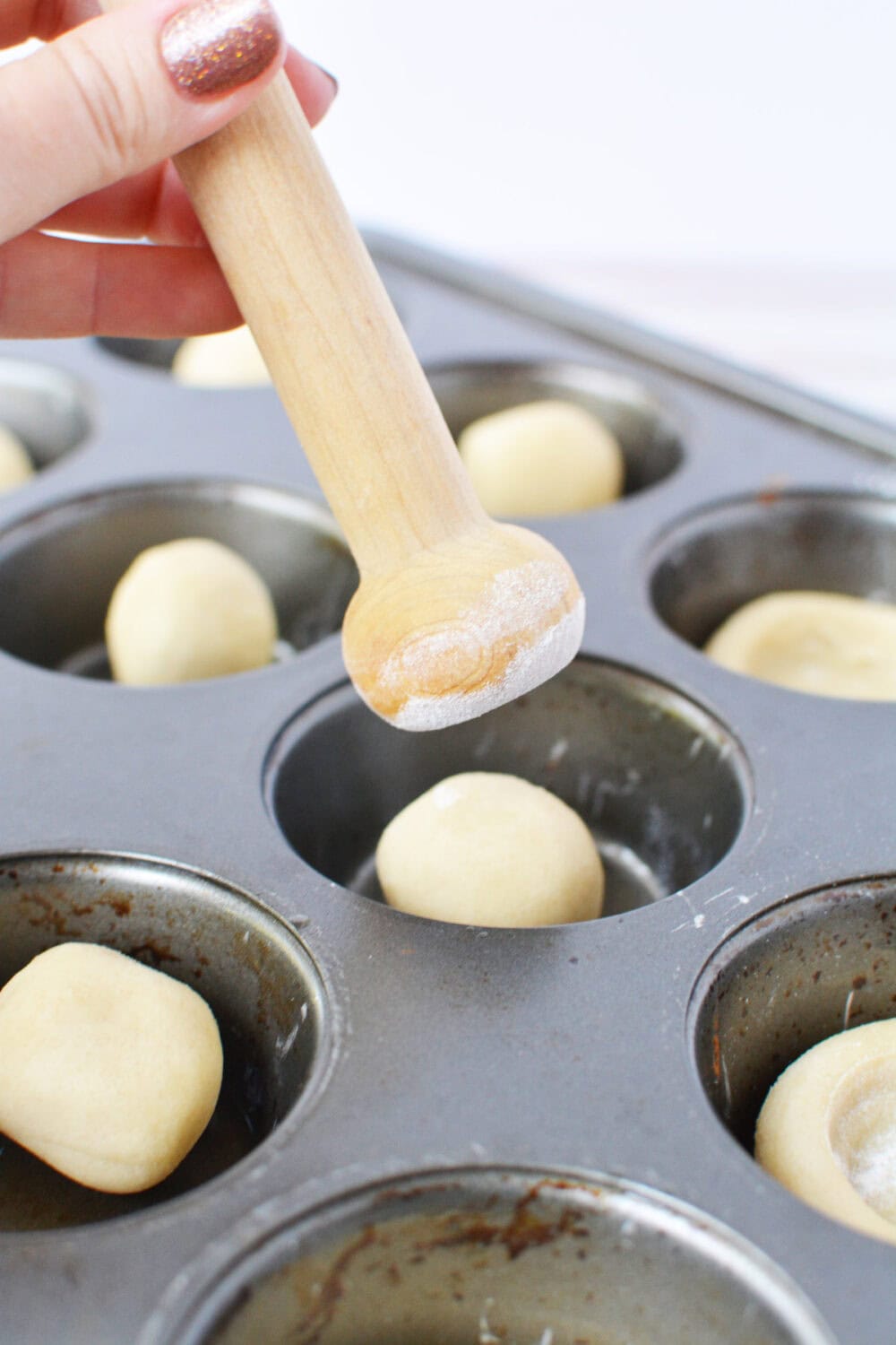 Using a tart shaper to shape dough.