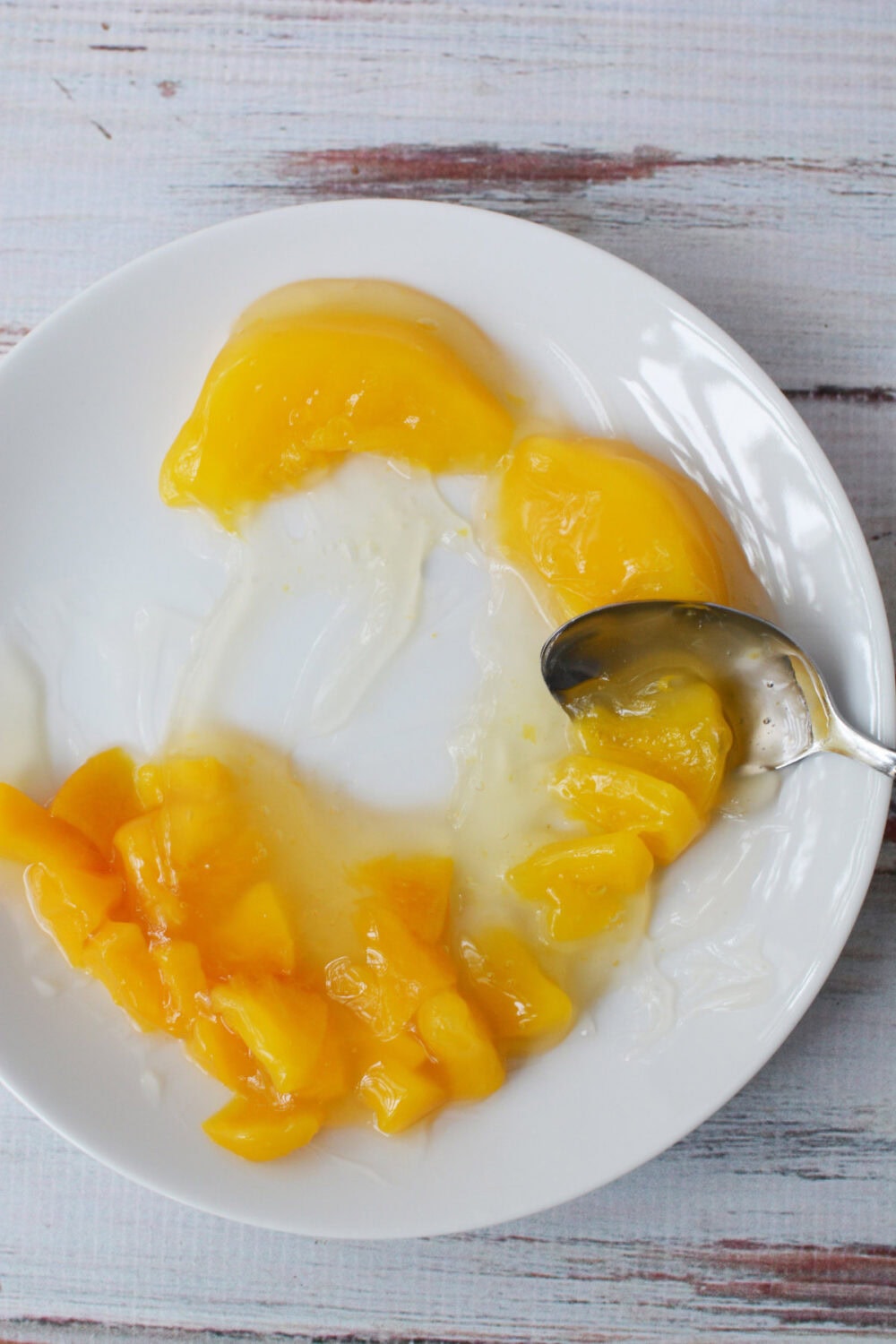 Cutting peach pie filling with a spoon.