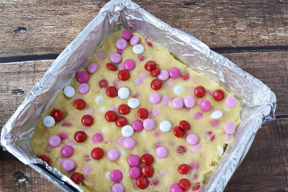 Topping cookie bars with more M&Ms.