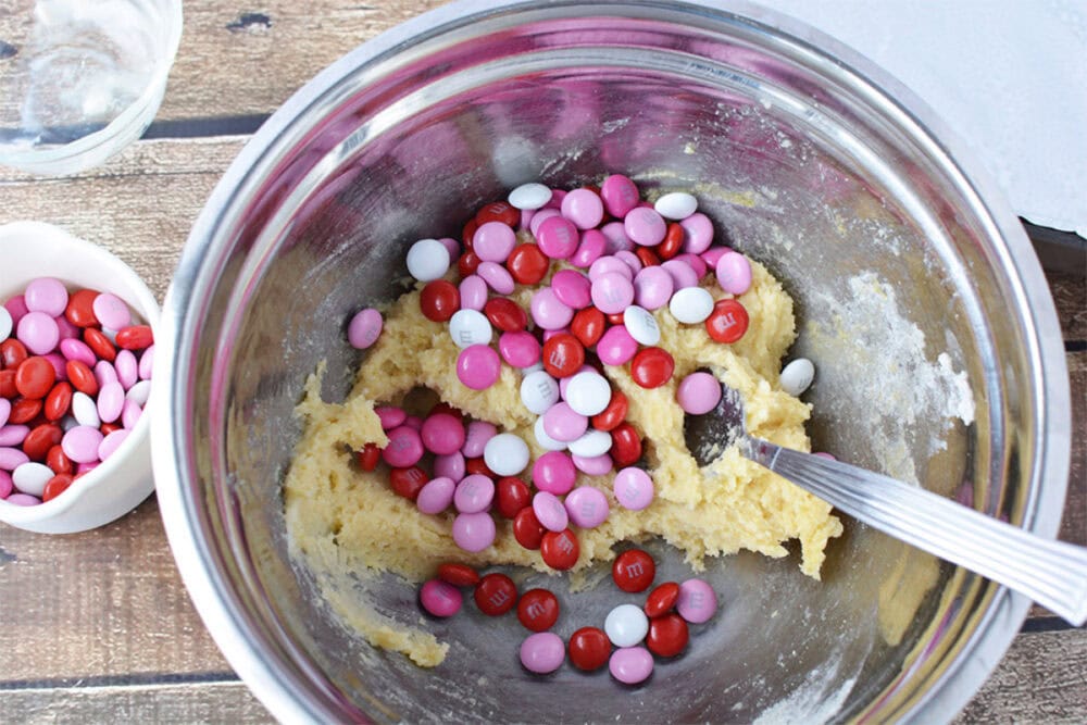Stirring in Valentine's Day M&Ms. 