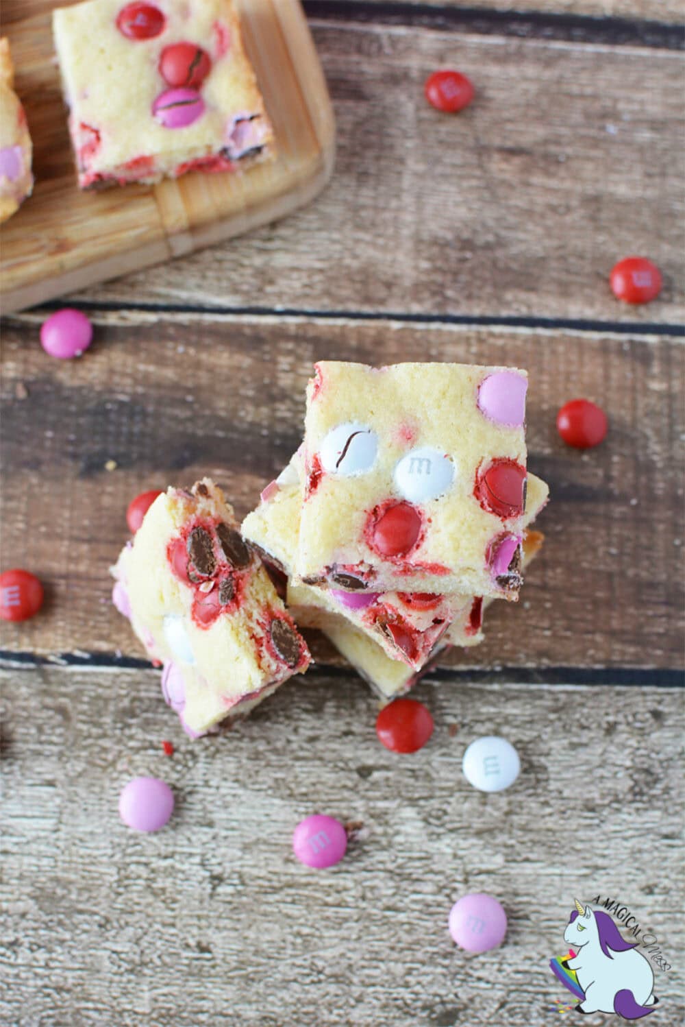 Valentine's Day sugar cookie bars next to M&Ms. 