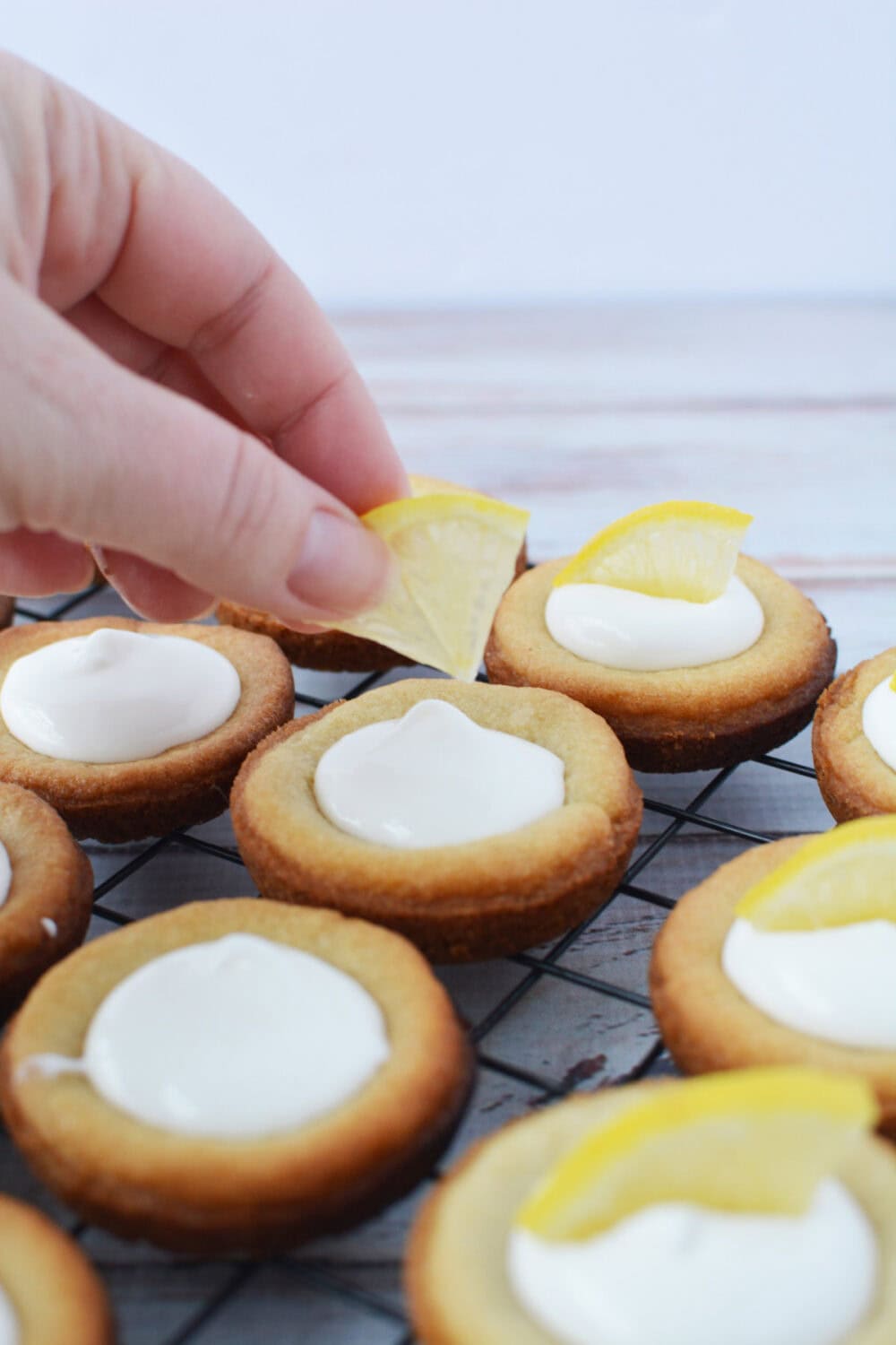 Adding lemon slice to lemonade pie cookies. 