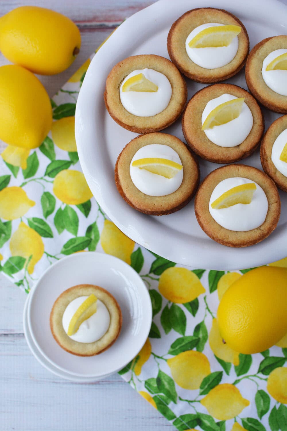 Plate of lemonade pie cookies with lemons all around. 