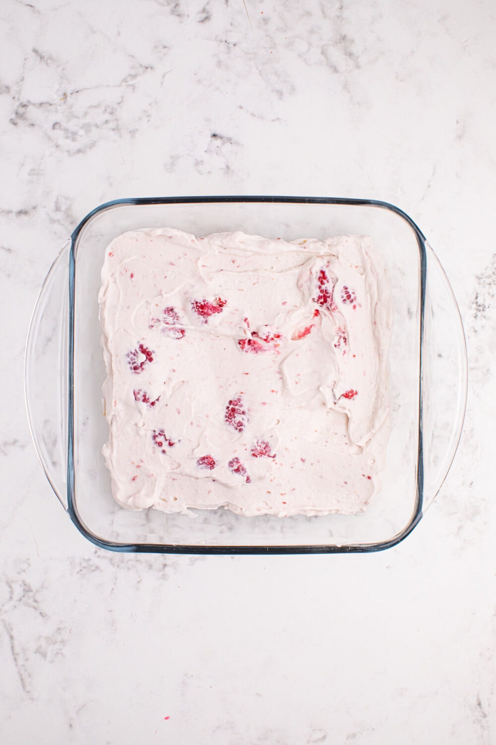 Raspberry whipped cream in a glass dish.