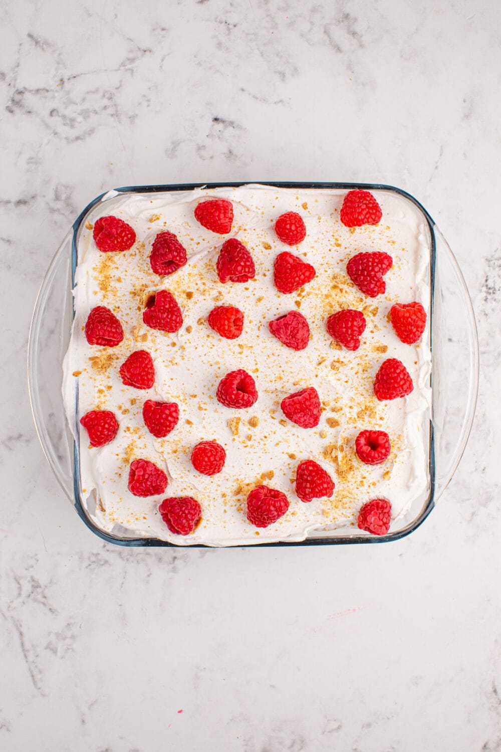 Fresh raspberries on top of whipped cream.