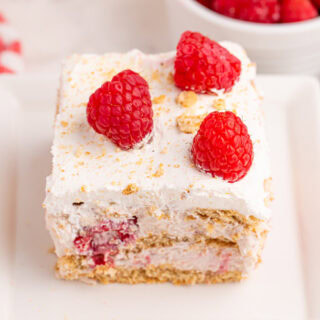 Slice of raspberry ice box cake on a plate.