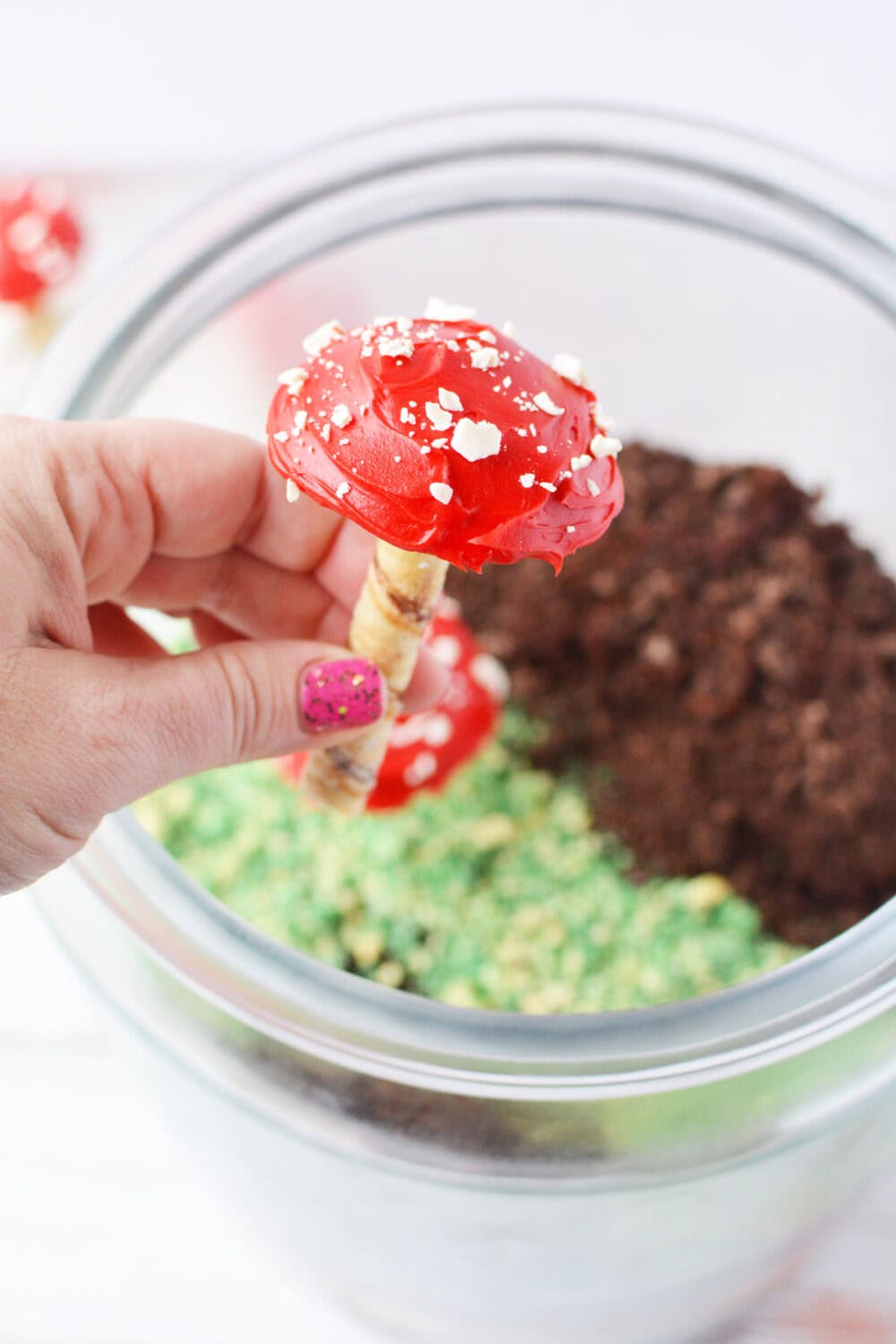 Holding a cookie mushroom over a jar