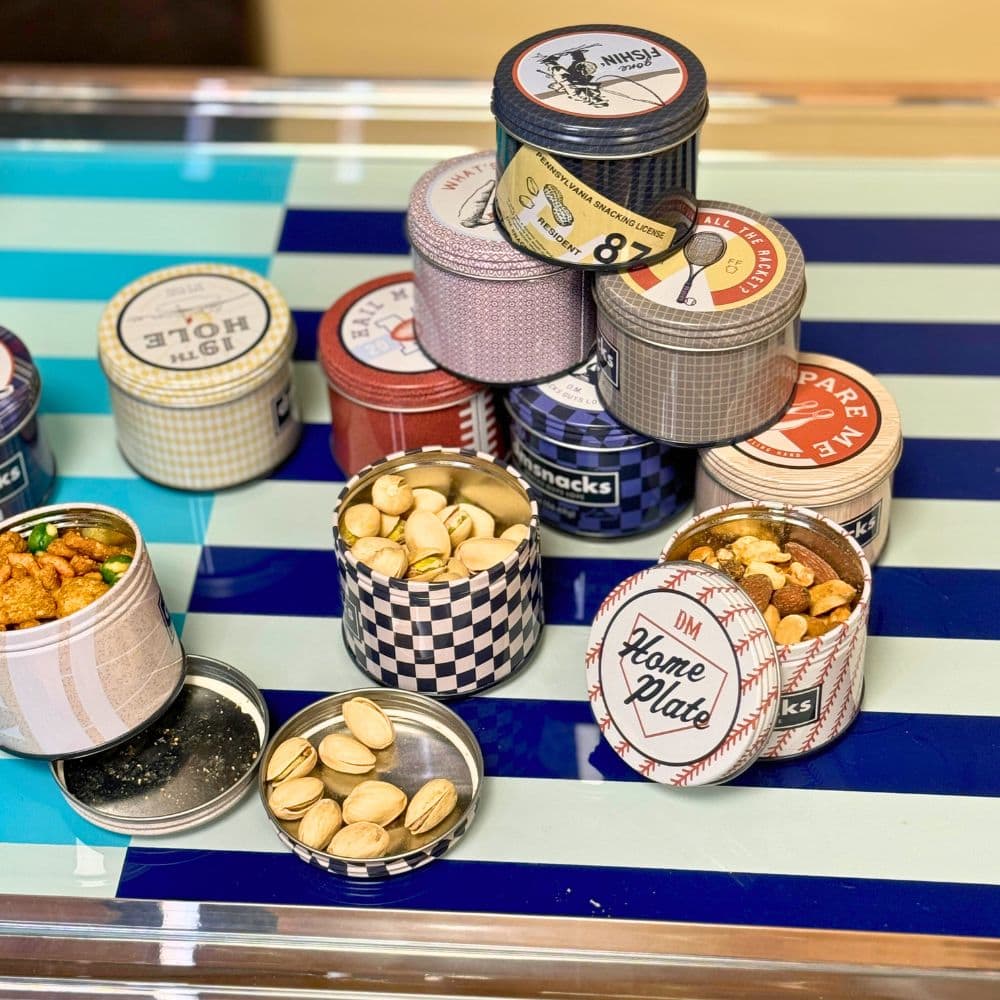 Sports-themed tins filled with nuts and snack mix.