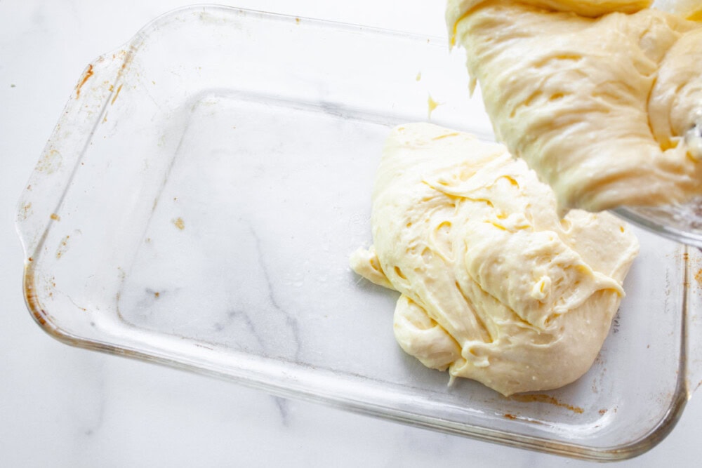 Pouring cake batter into a pan.