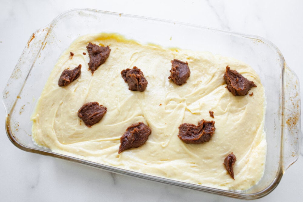 Cinnamon filling dropped onto cake batter.