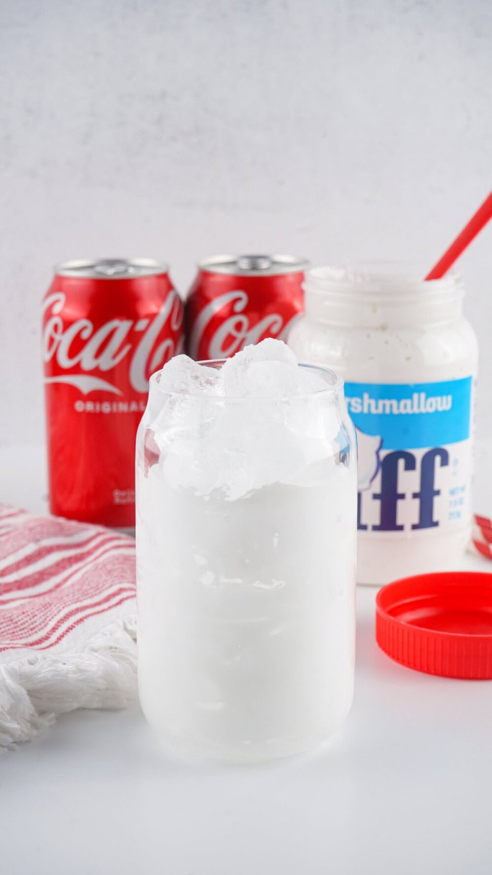 Glass coated with Marshmallow Fluff and filled with ice.