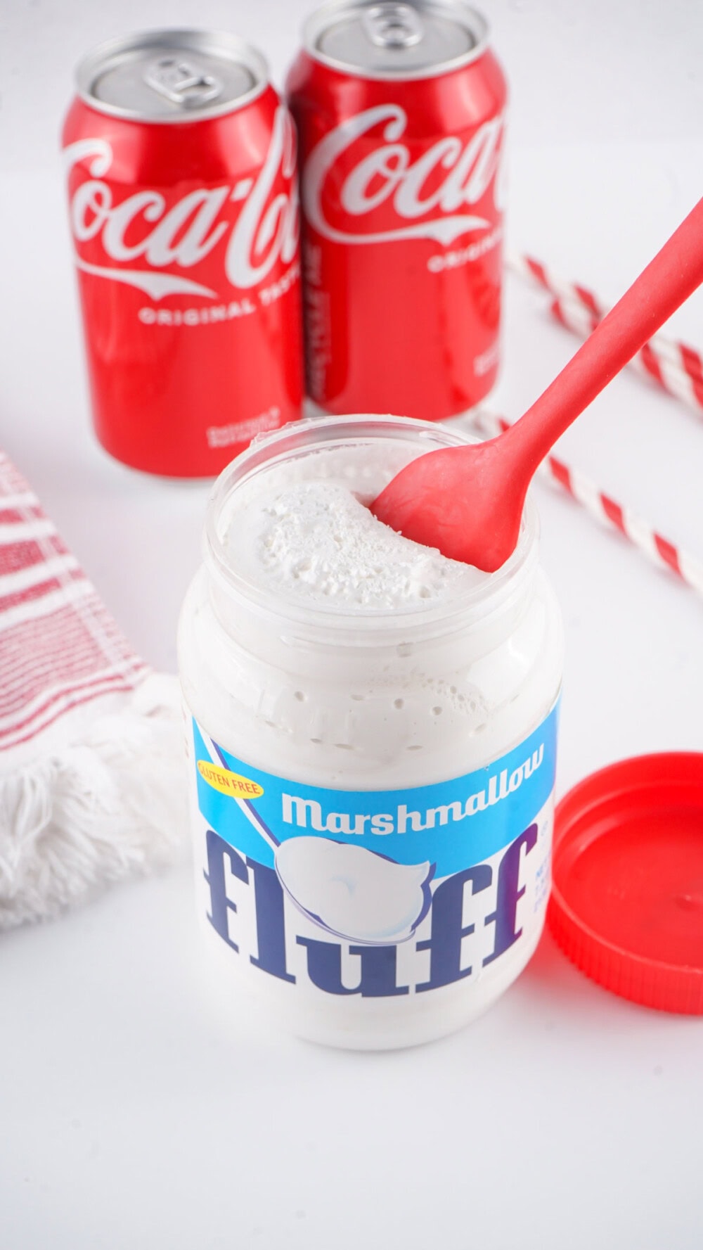 Using a spatula in a jar of Marshmallow Fluff.