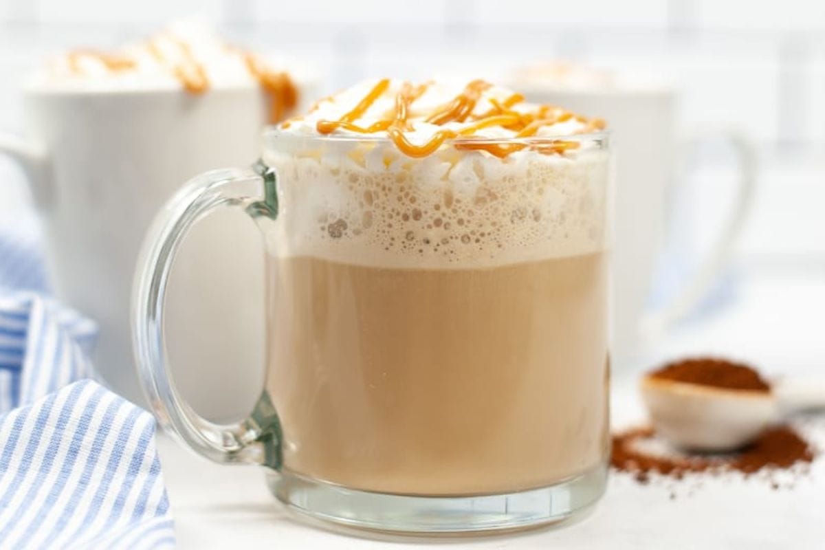 Caramel coffee drink in a clear mug.