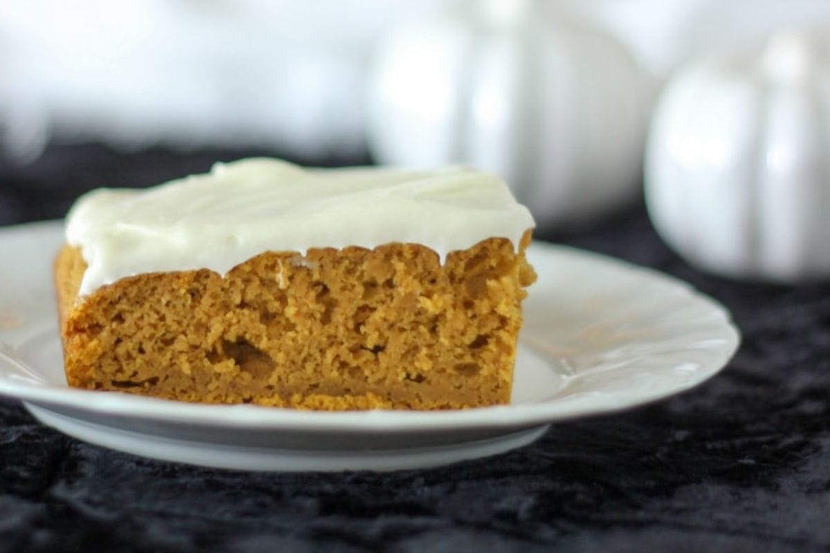 Pumpkin square with frosting on a plate.