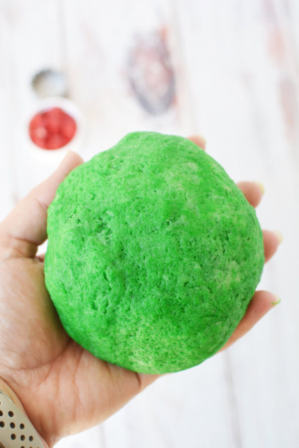 Ball of green colored cookie dough.