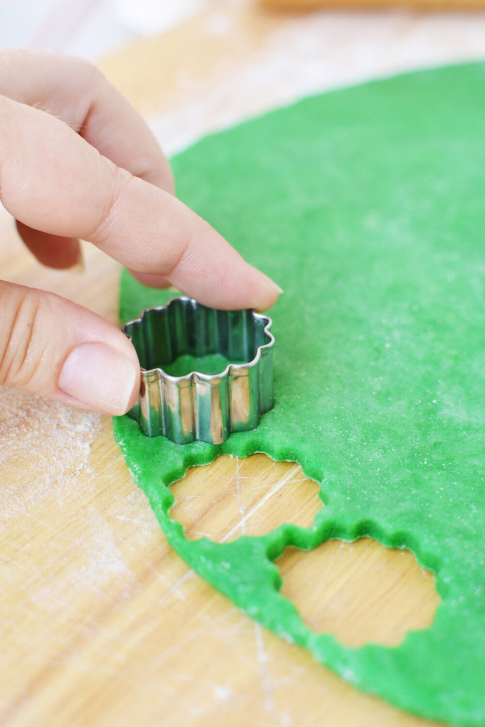 Cutting dough with small cookie cutter.