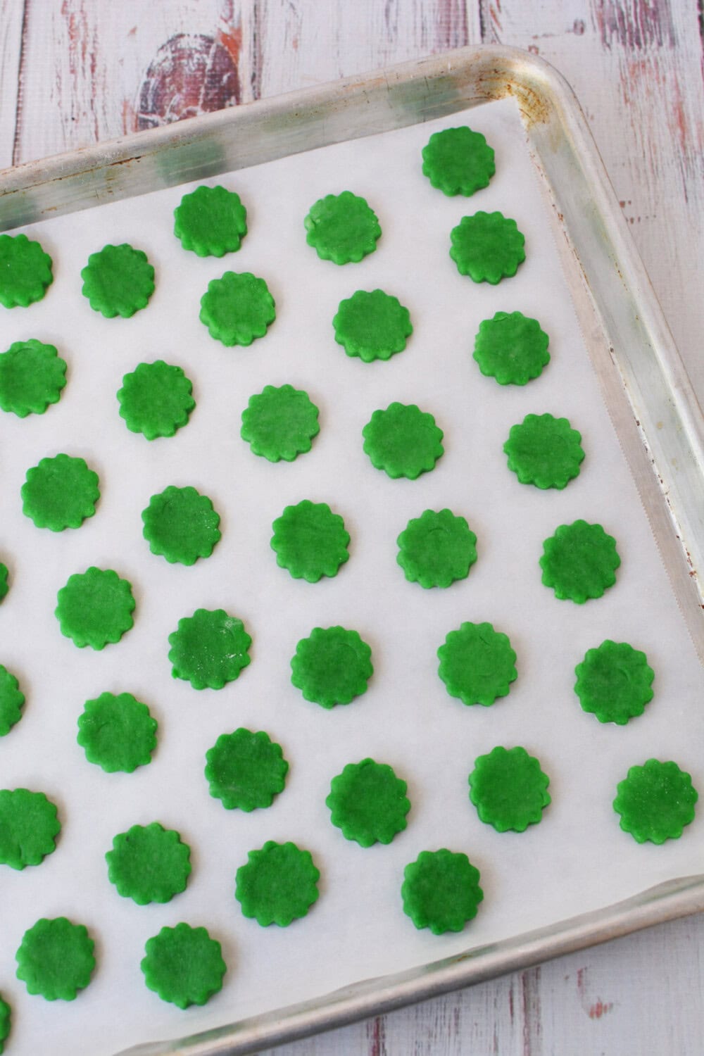 Small dough shapes on baking sheet.