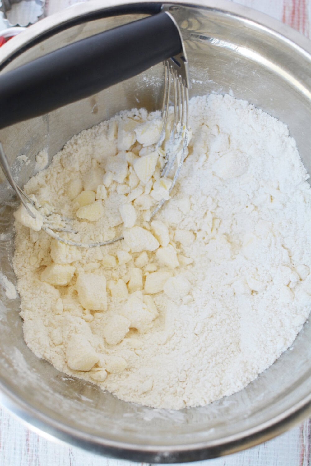 Butter mixing into flour and sugar mixture.