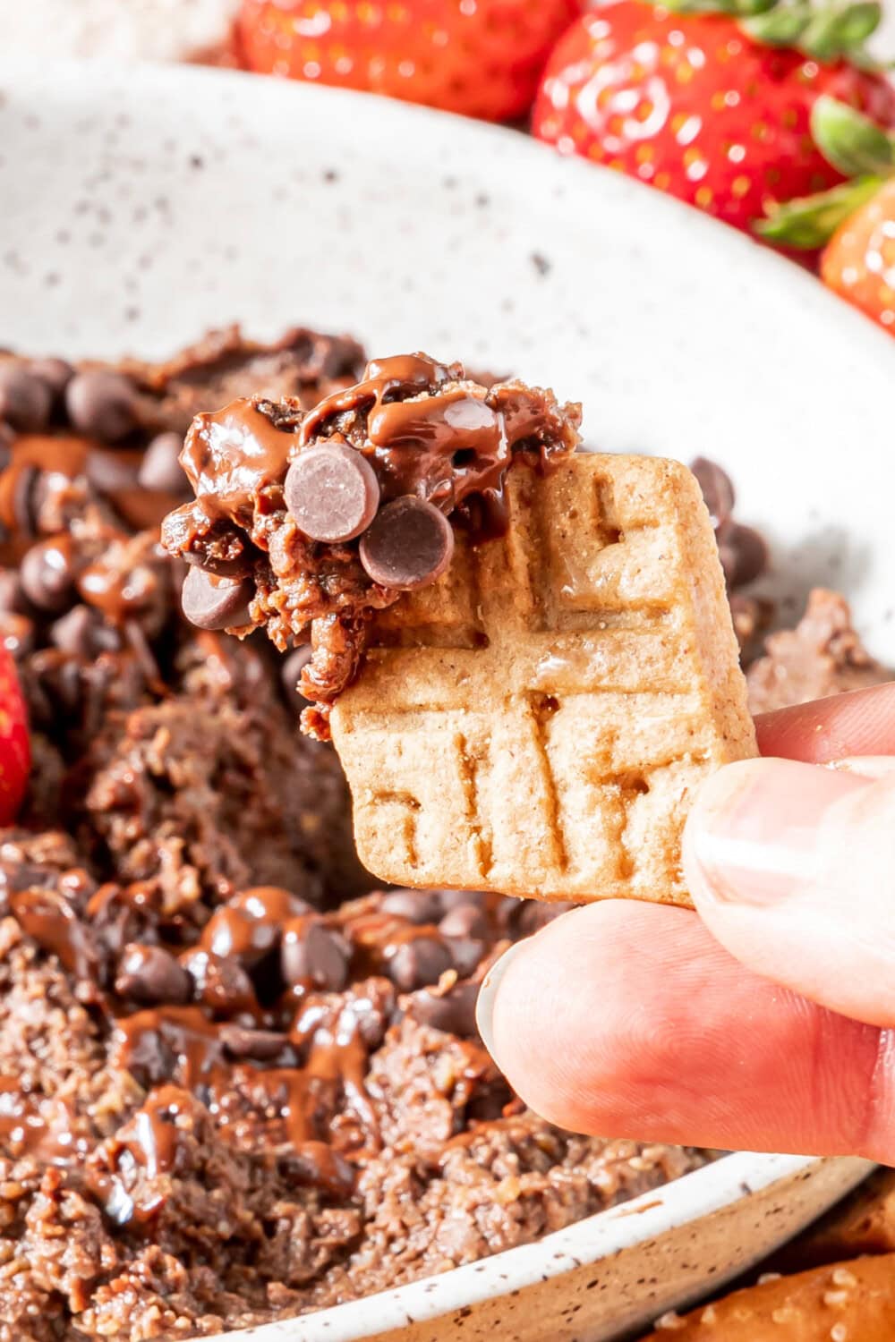 Dipping a cracker into chocolate hummus.