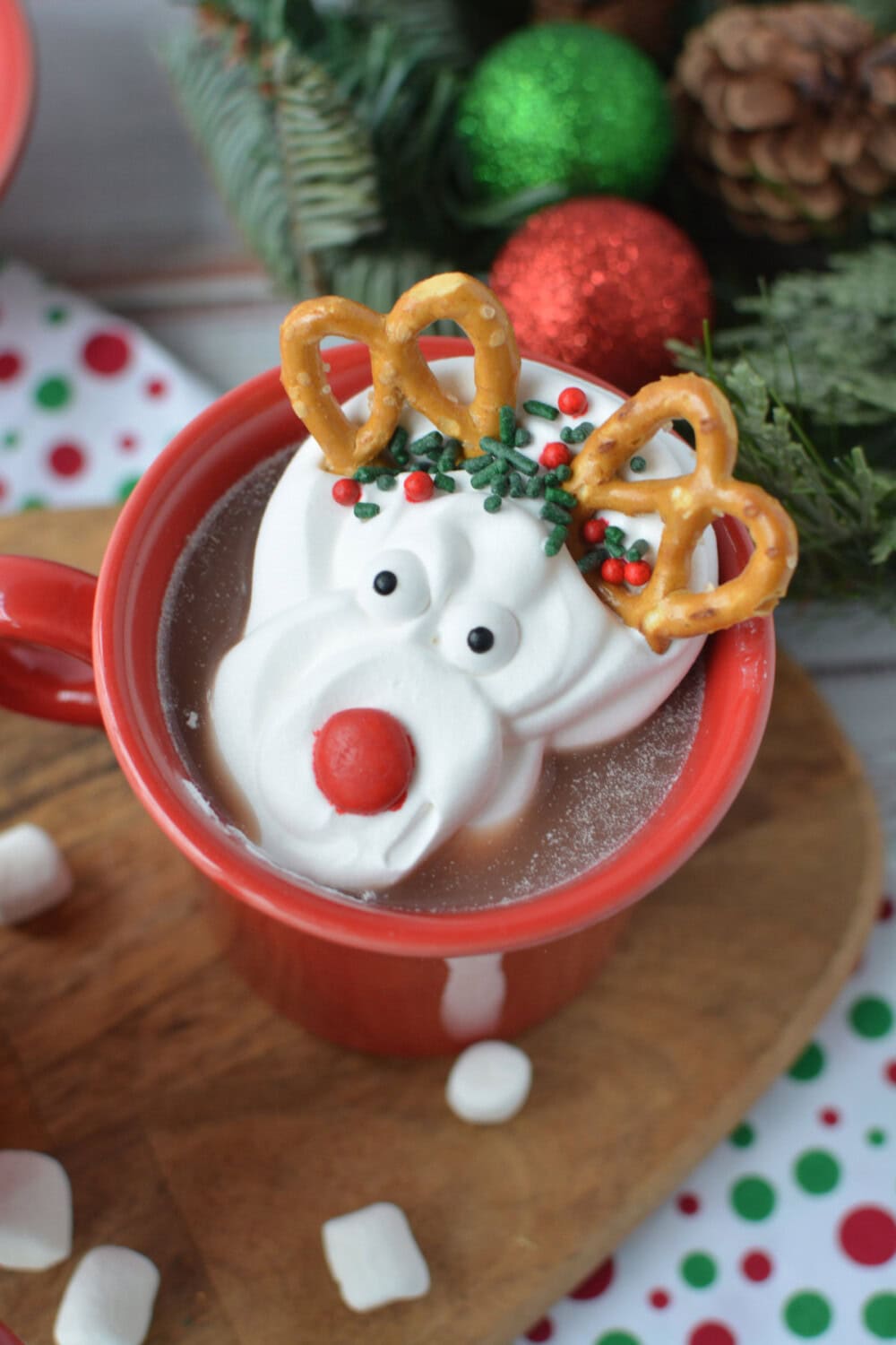 Reindeer whipped cream on top of a red mug with hot chocolate