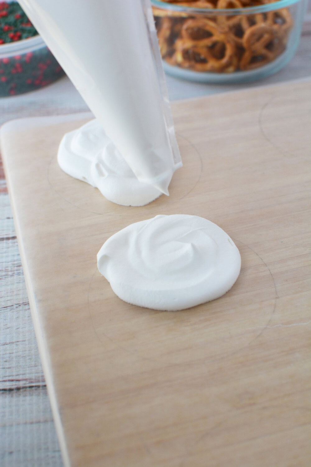 Piping whipped cream onto parchment paper