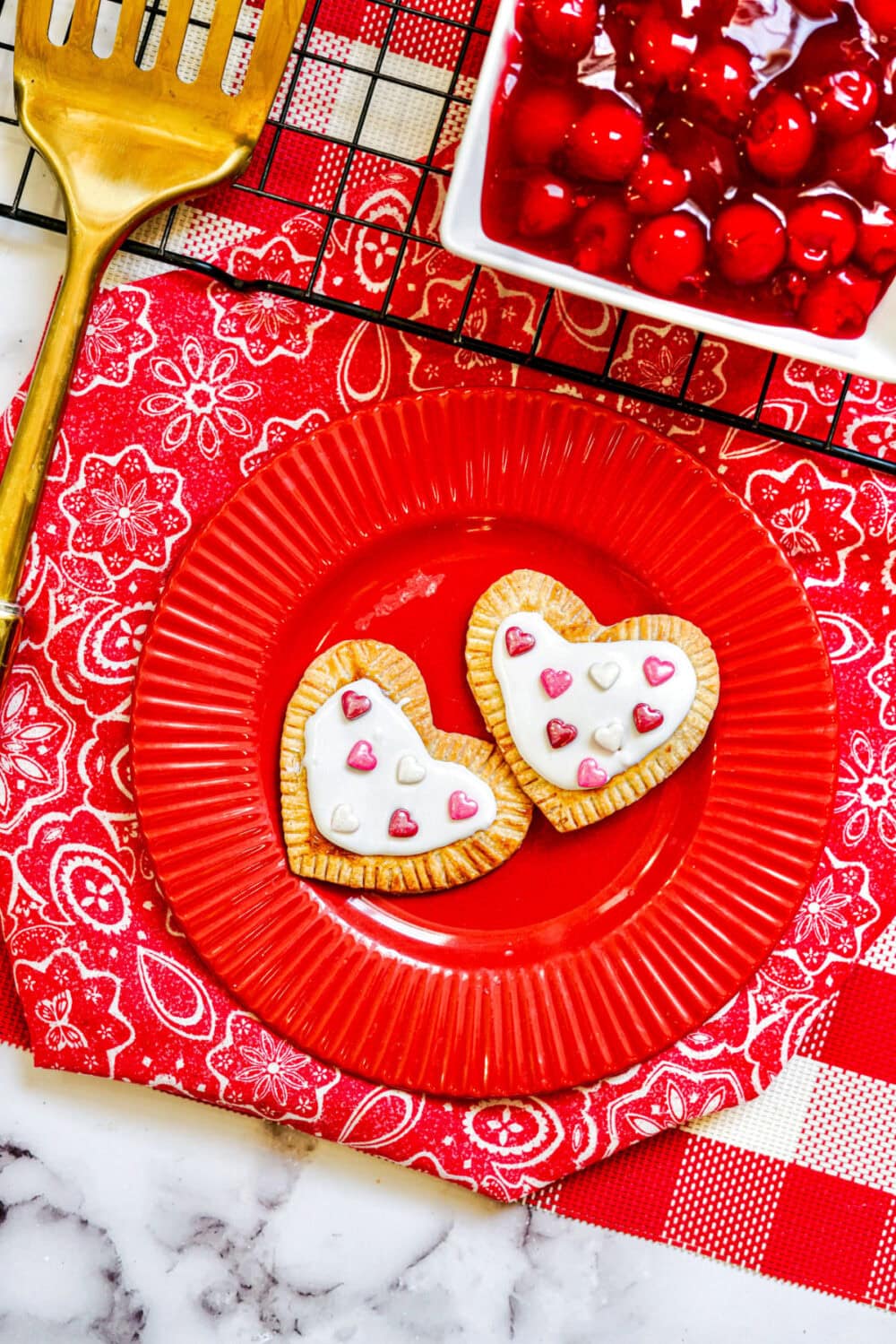 Heart pastries on a red plate.