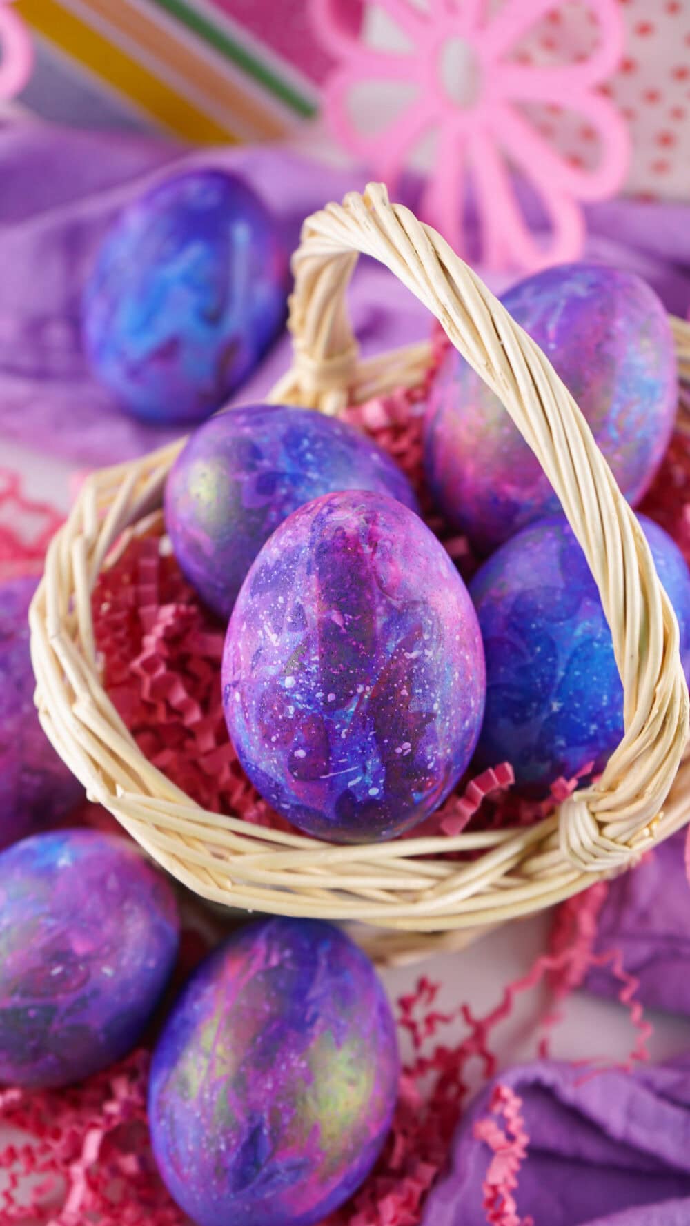 Dyed galaxy Easter eggs in a basket.