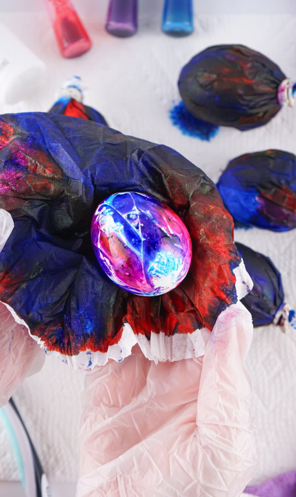 Unwrapping a dyed egg.