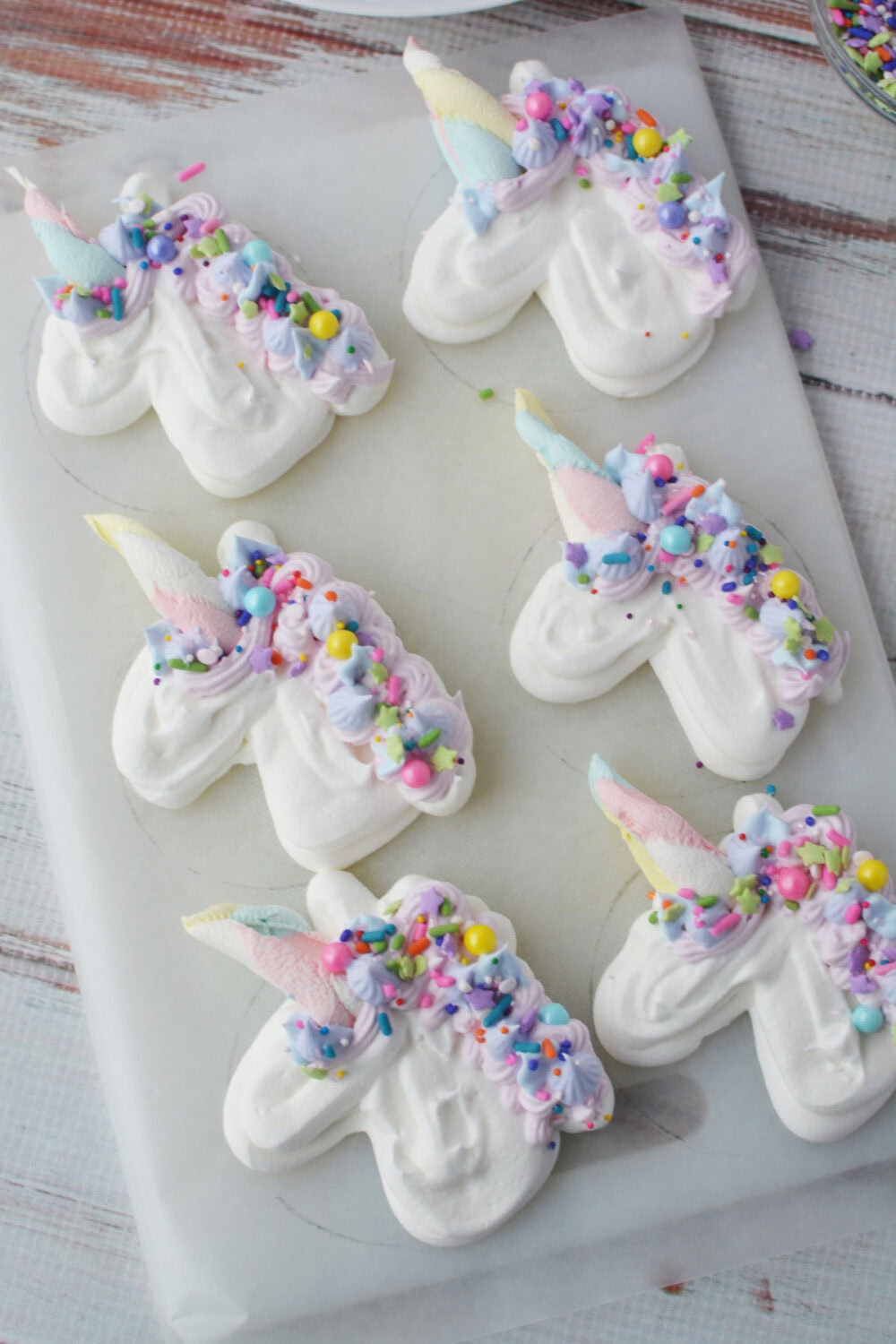 Decorated and sprinkled whipped topping unicorns