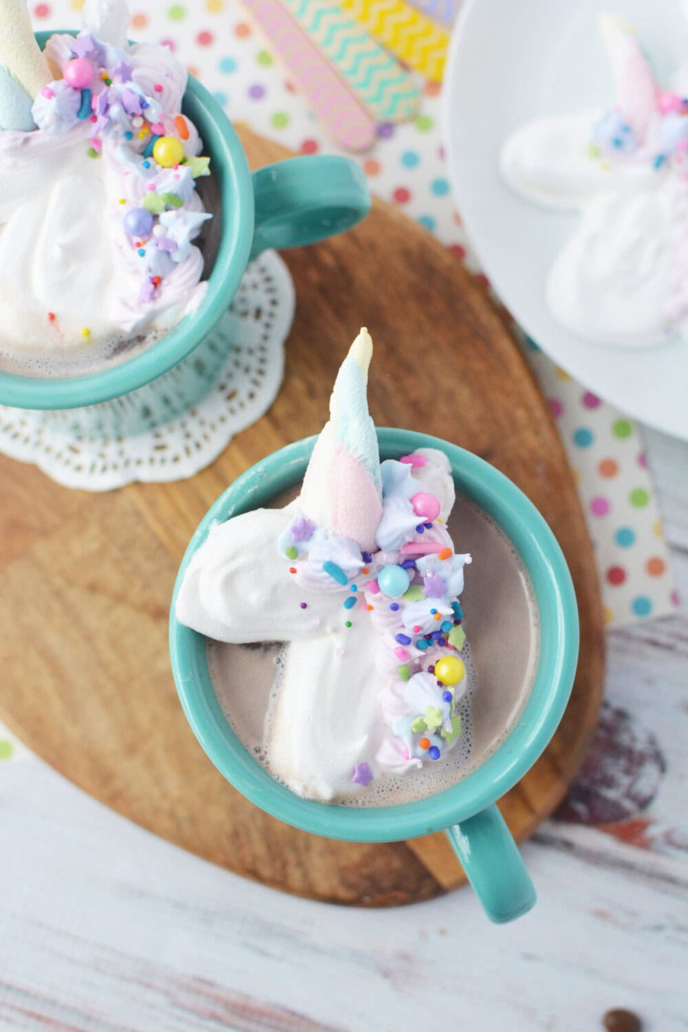 Unicorn whipped topping on top of a mug full of hot chocolate.