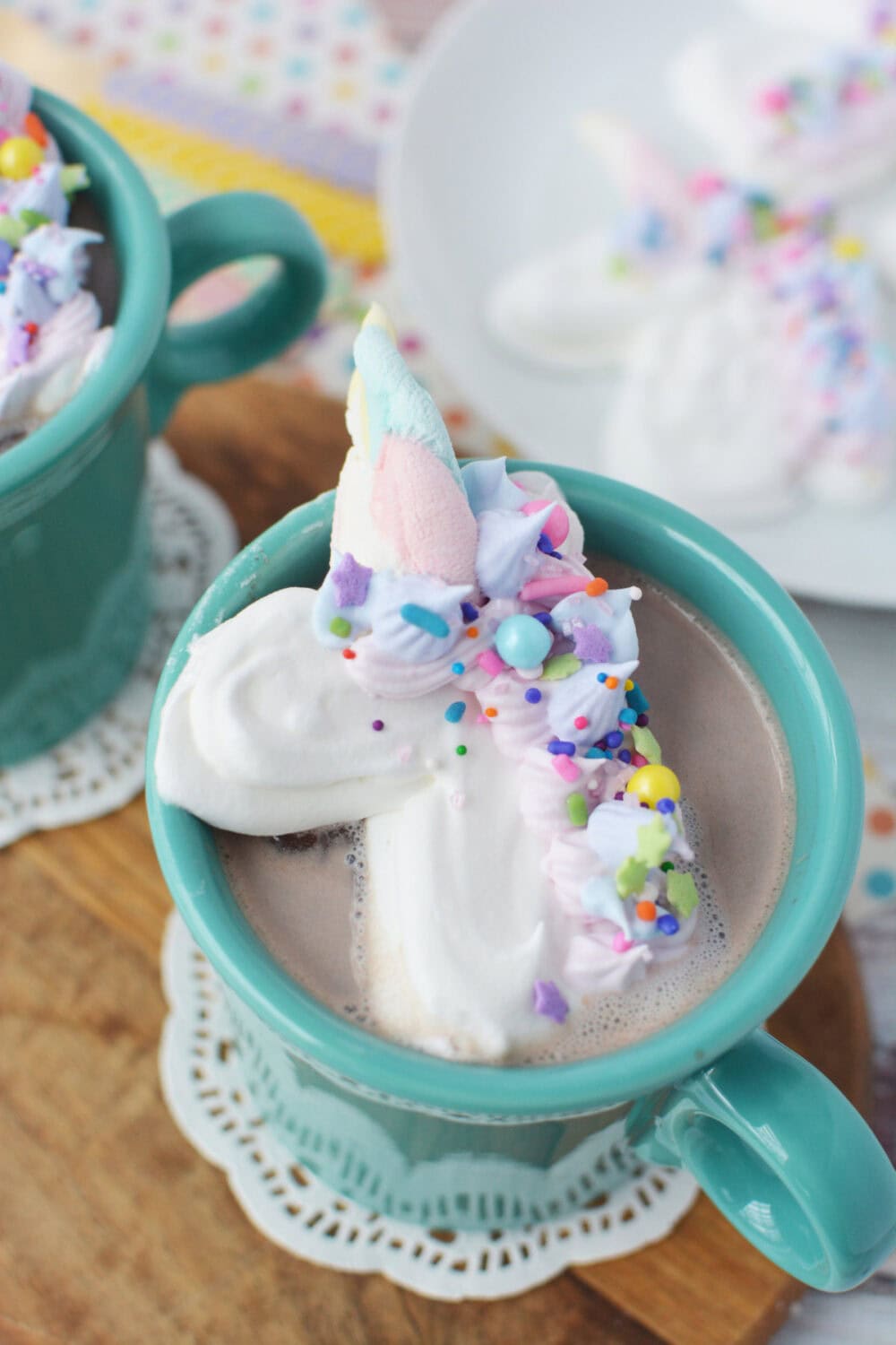 Mug of hot cocoa topped with a whipped cream unicorn
