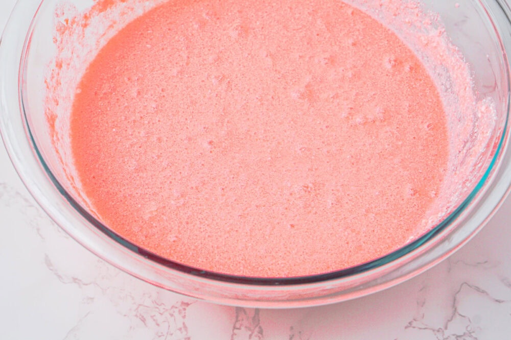 pink jello mixture in a bowl