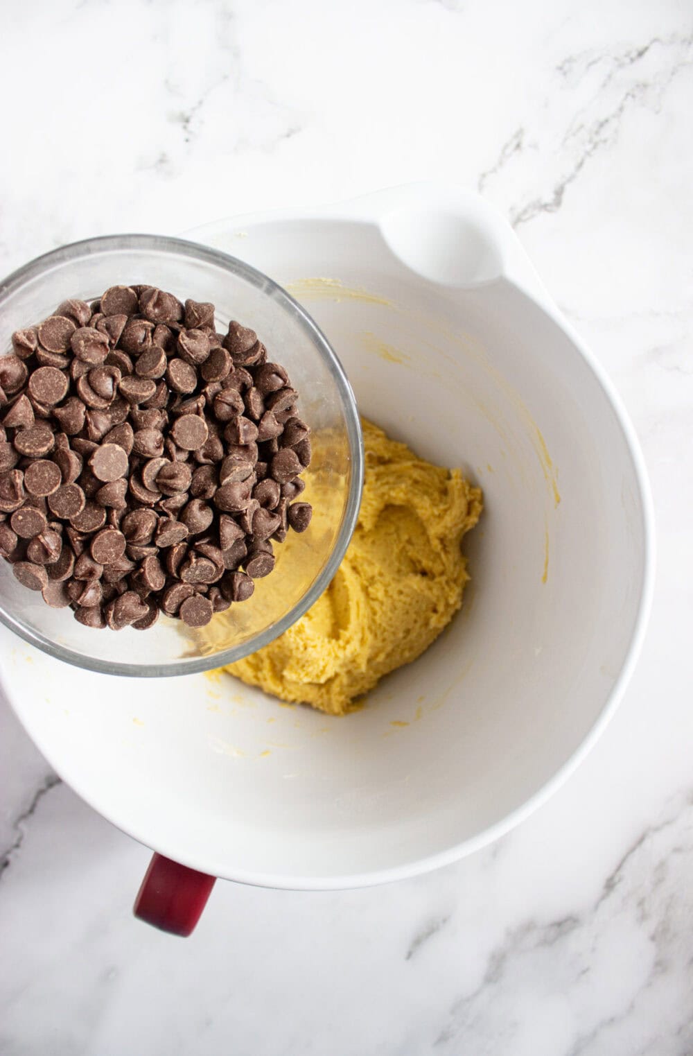 chocolate chips going into cookie dough